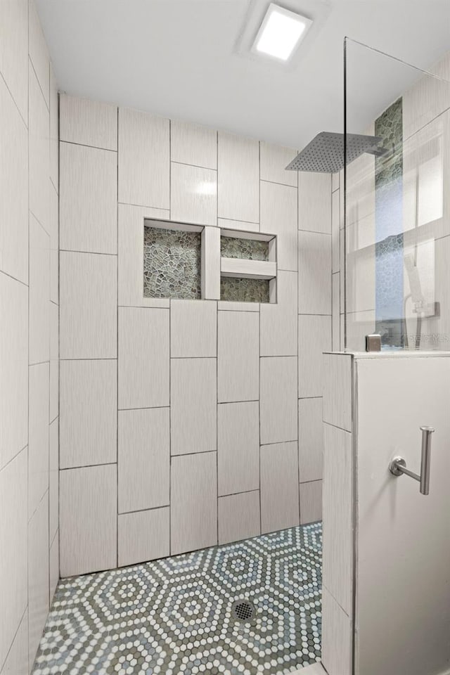 bathroom with a tile shower