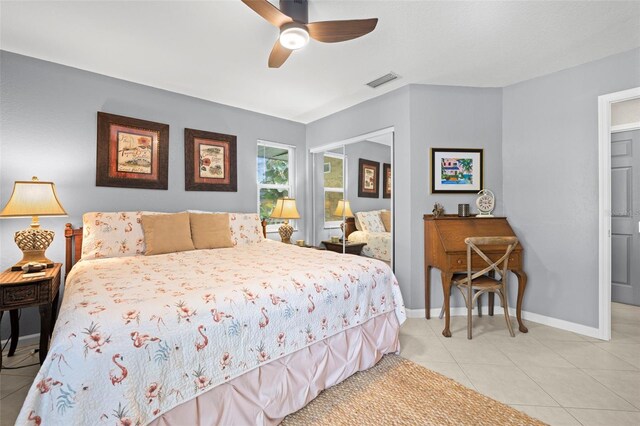 tiled bedroom featuring ceiling fan