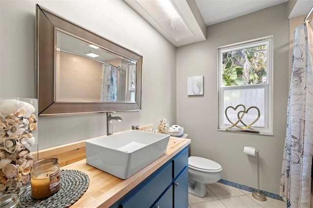 bathroom with vanity, toilet, and tile patterned floors