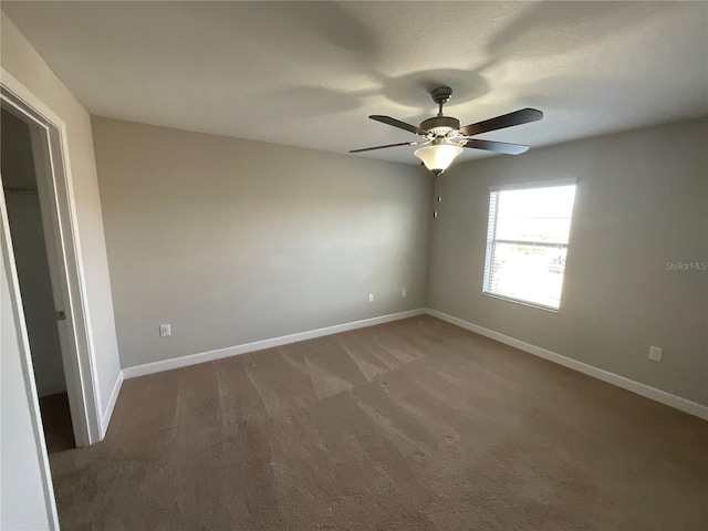 carpeted empty room with ceiling fan