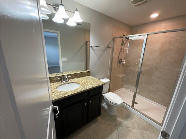 bathroom featuring a shower with shower door, tile patterned flooring, vanity, a notable chandelier, and toilet