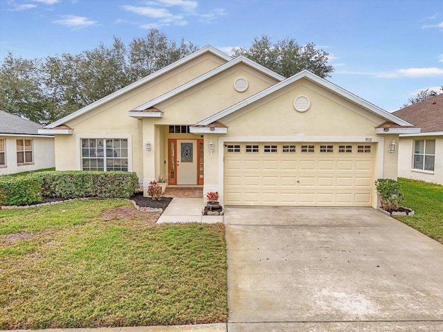 view of front of house with a front yard and a garage