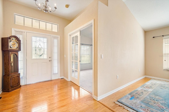 entrance foyer with a notable chandelier and hardwood / wood-style flooring