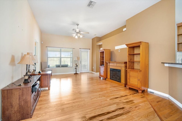 living room featuring ceiling fan and light wood-type flooring