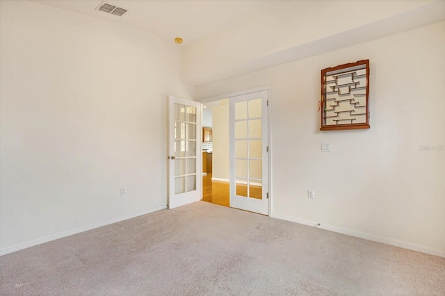 carpeted empty room with french doors