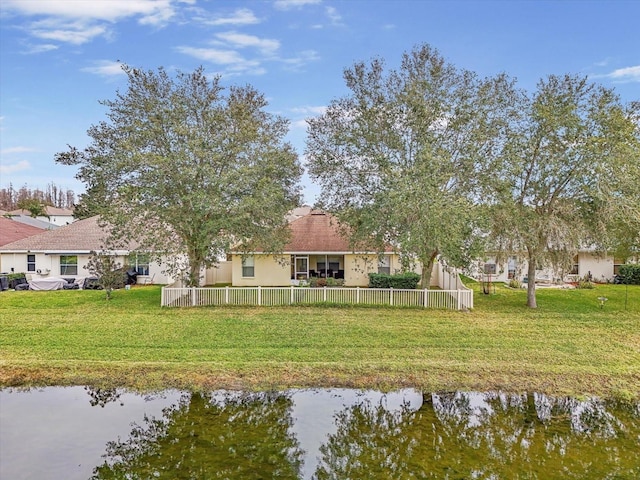 exterior space with a water view and a yard