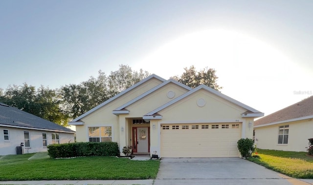 9551 Jaybird Ln, Land O Lakes, FL 34638 - ranch-style house with a front lawn, stucco siding, concrete driveway, and an attached garage