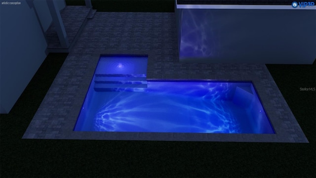 view of swimming pool with an in ground hot tub