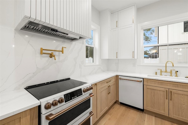 kitchen with electric stove, custom range hood, decorative backsplash, a sink, and dishwasher