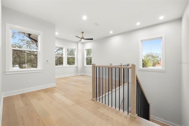 empty room featuring baseboards, wood finished floors, visible vents, and recessed lighting