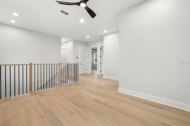 empty room featuring ceiling fan, recessed lighting, visible vents, baseboards, and light wood-style floors