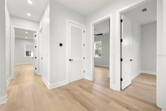 corridor with baseboards, recessed lighting, visible vents, and light wood-style floors