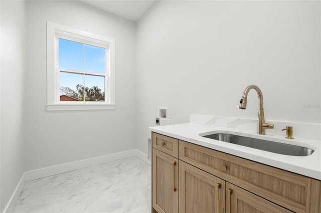 laundry room with hookup for an electric dryer, washer hookup, a sink, marble finish floor, and cabinet space