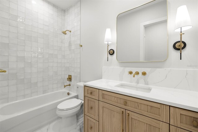 bathroom with toilet, vanity, and shower / bathing tub combination