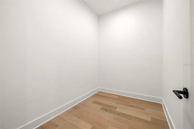 empty room with light wood-style floors and baseboards