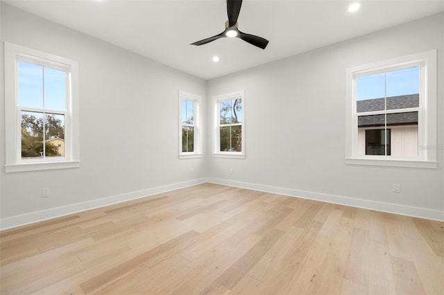 spare room with a ceiling fan, light wood-type flooring, baseboards, and recessed lighting