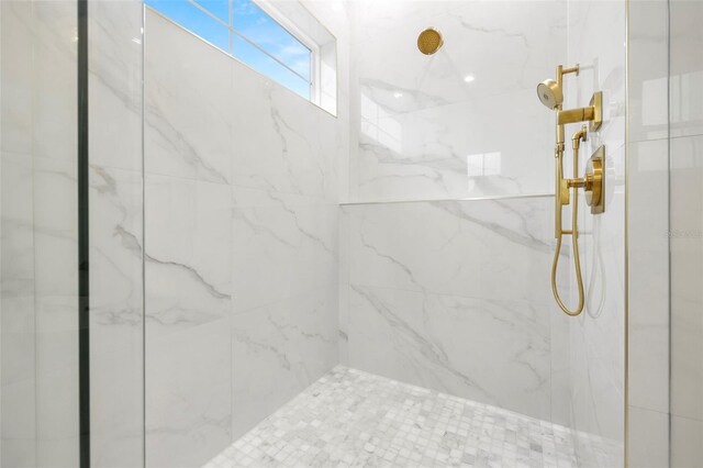 full bathroom with a marble finish shower