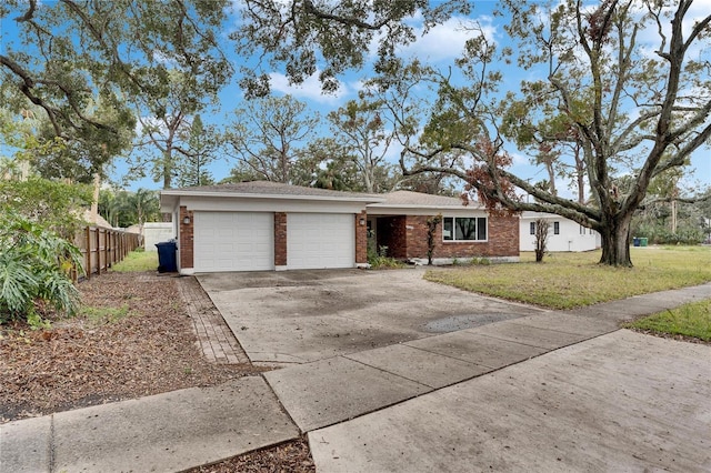 ranch-style home with a garage and a front yard