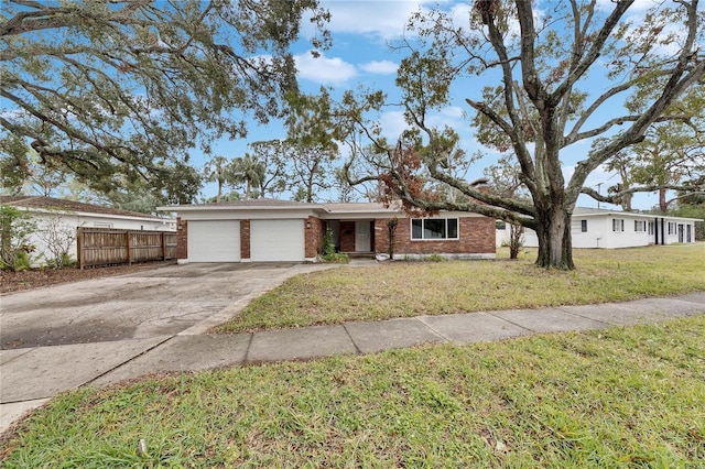 single story home with a garage and a front lawn