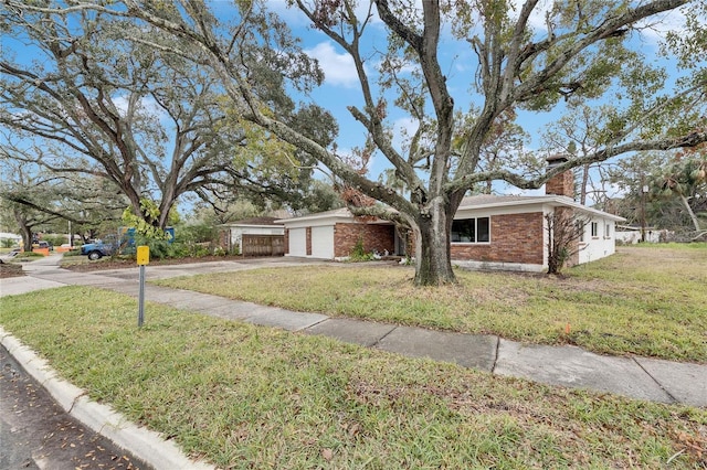 single story home featuring a garage and a front yard