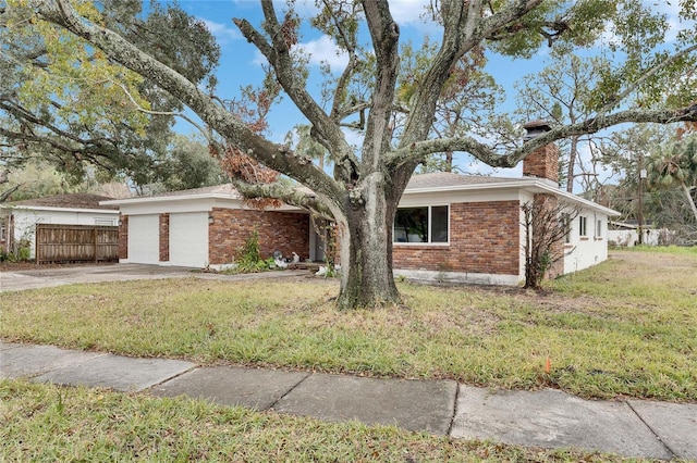 view of front of home featuring a garage and a front lawn