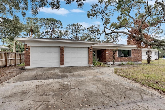 single story home with a garage and a front lawn