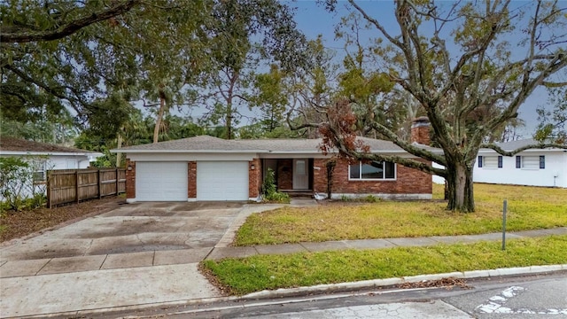 ranch-style home featuring a garage and a front yard