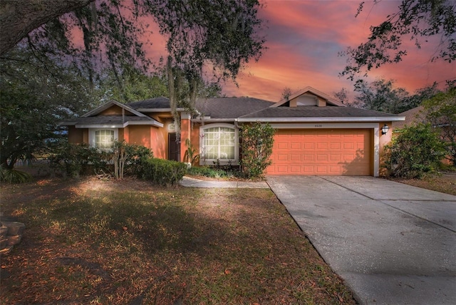 ranch-style home featuring a yard and a garage