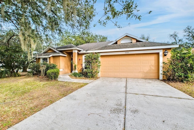 single story home with a garage and a front yard