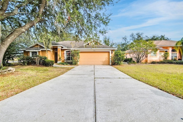 single story home featuring a garage and a front lawn