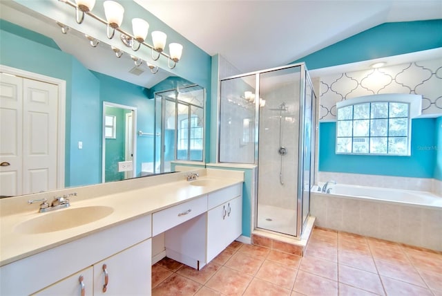 bathroom with vanity, vaulted ceiling, shower with separate bathtub, and tile patterned floors