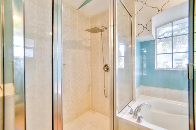 bathroom featuring shower with separate bathtub