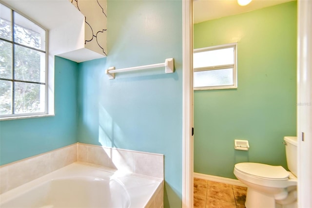 bathroom with toilet, tile patterned flooring, and a bathing tub