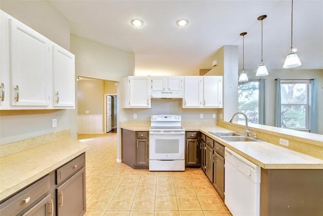 kitchen featuring pendant lighting, sink, white cabinetry, light tile patterned flooring, and white appliances