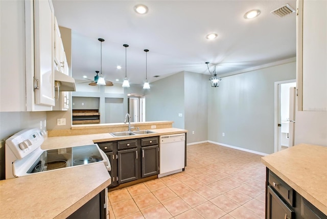 kitchen with white appliances, light tile patterned floors, white cabinets, decorative light fixtures, and sink