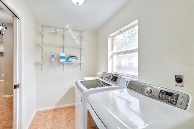 washroom with light tile patterned floors and washing machine and clothes dryer