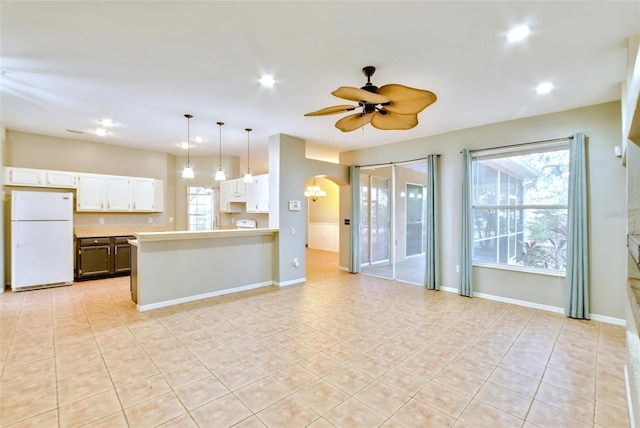 kitchen with white cabinetry, pendant lighting, ceiling fan, white refrigerator, and light tile patterned flooring