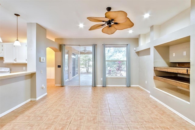 tiled empty room with ceiling fan