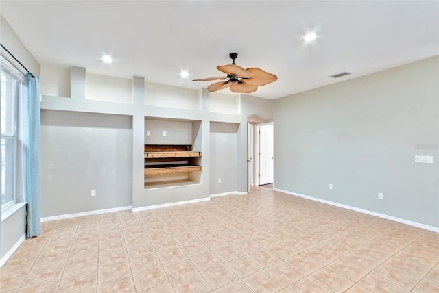 unfurnished living room with ceiling fan and light tile patterned floors