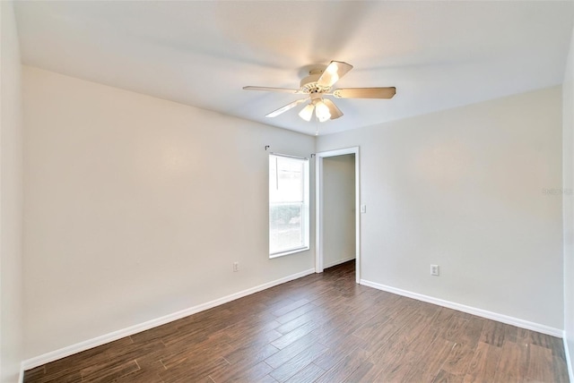 empty room featuring ceiling fan and dark wood-type flooring