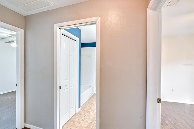 corridor with light tile patterned flooring