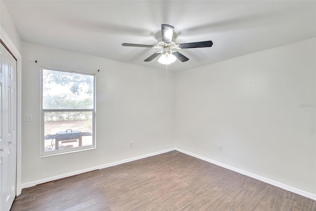 unfurnished room with hardwood / wood-style flooring and ceiling fan