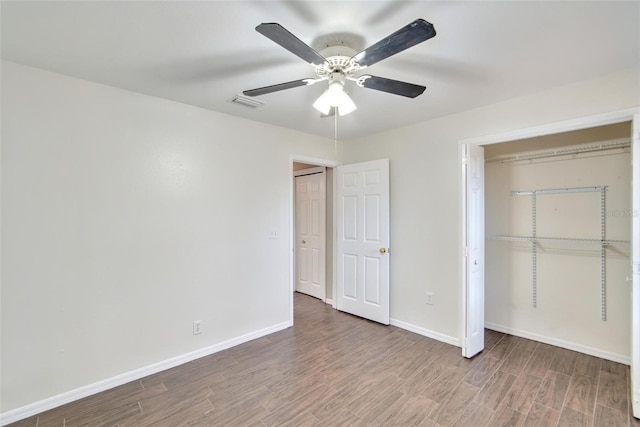 unfurnished bedroom with hardwood / wood-style floors, a closet, and ceiling fan