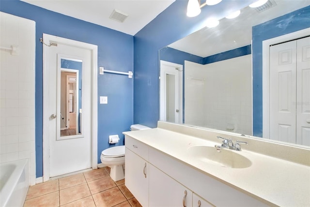 bathroom featuring tile patterned floors, vanity, and toilet