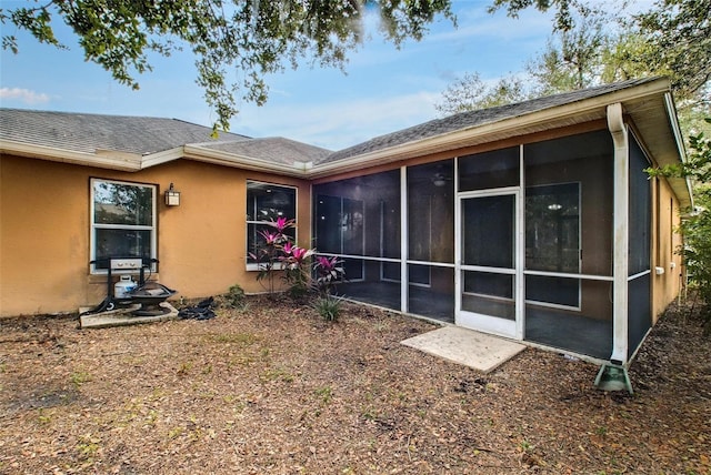 view of home's exterior with a sunroom