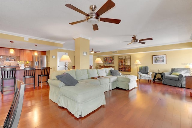 living room featuring ornamental molding and dark hardwood / wood-style flooring