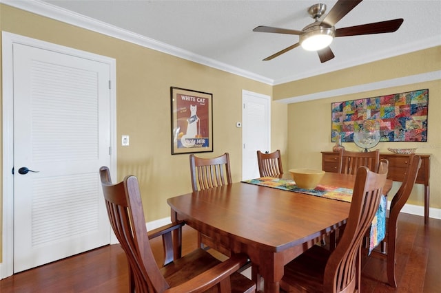 dining space with crown molding, dark wood-type flooring, and ceiling fan