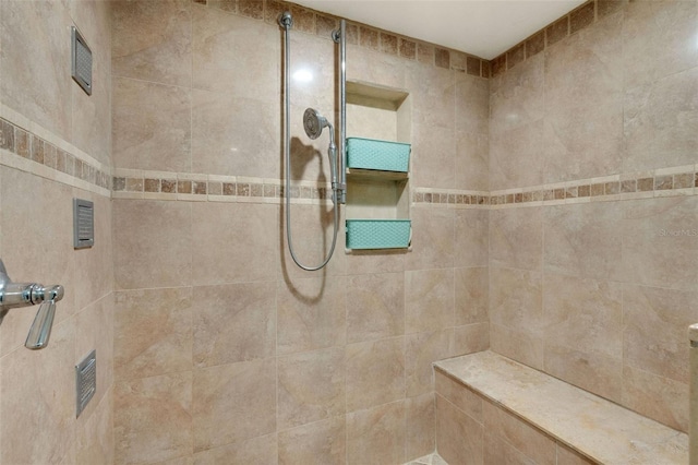 bathroom with a tile shower