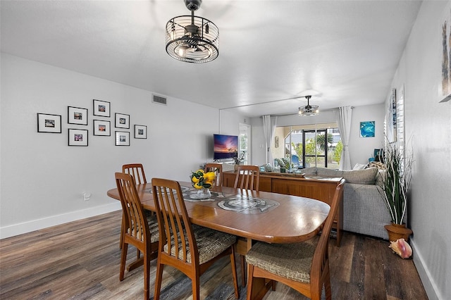 dining space with ceiling fan and hardwood / wood-style flooring