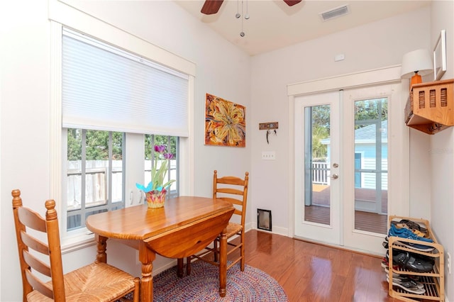 dining room with hardwood / wood-style flooring, a wealth of natural light, french doors, and ceiling fan